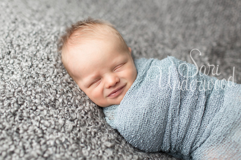 12 day old newborn boy smiling