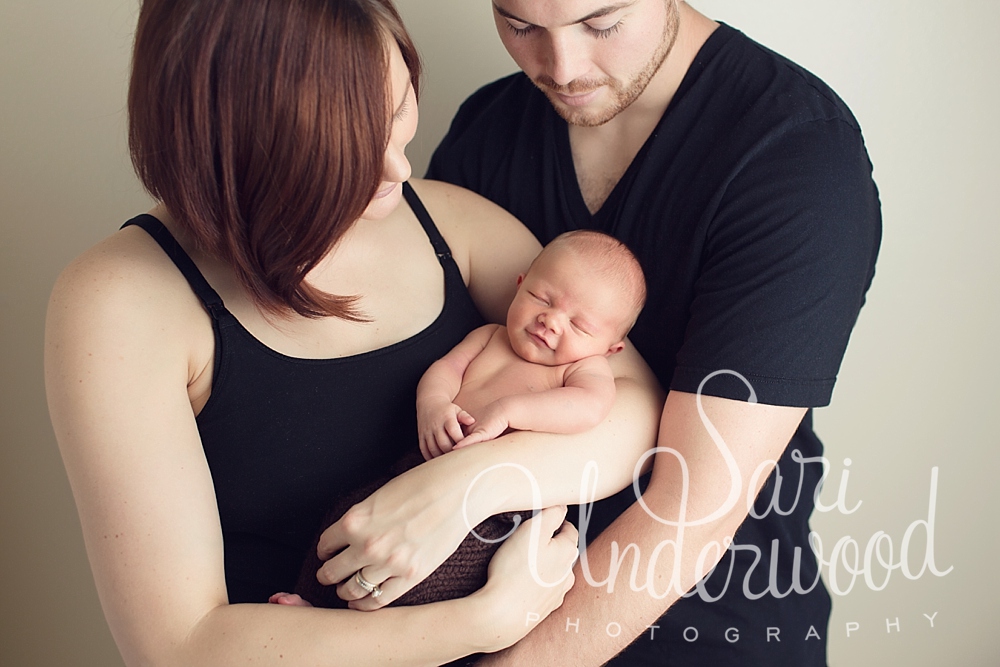 sweet family of 3 with newborn boy